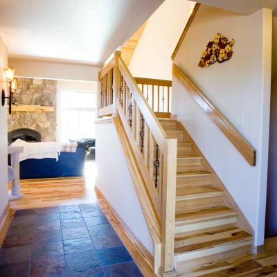 Ceramic tile entry, Natural wood stairs and wood railing, looking into living room