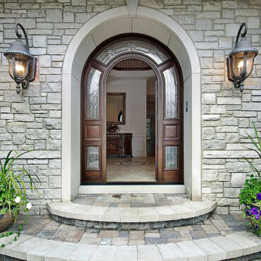 Stone front entry with dome shaped door