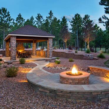 Brick gazebo with fireplace and firepit with circular brick seating