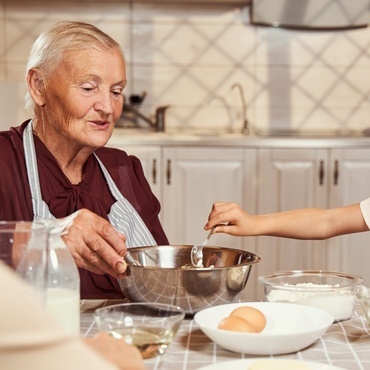Elder Woman baking with grand daughter