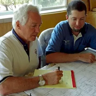 Skip Howes and Jon Howes reviewing blueprints