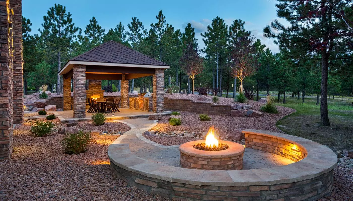 Brick gazebo with fireplace and firepit with circular brick seating