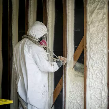 Spray foam insulation being installed in wall