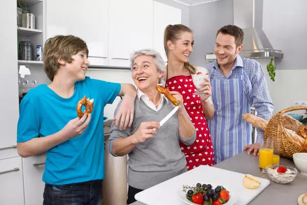 Happy family with the grandmother in the kitchen.