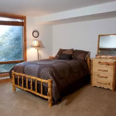 Master bedroom with carpet, double bed and floor to ceiling windows