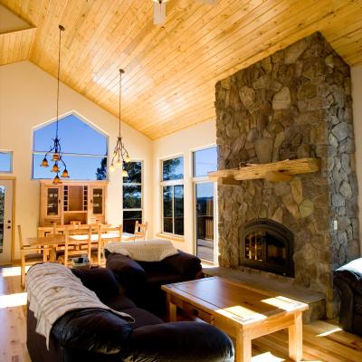 Family room with tongue and groove wood, vaulted ceilings and floor to ceiling rock fireplace.